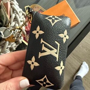SOLD
Louis Vuitton Black with Beige Monogram Mini Pouch and Chain